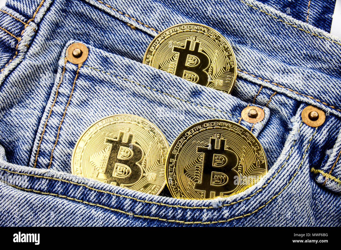 Three Golden Bitcoin C!   oins On The Pockets Of The Jeans Concept Of - 